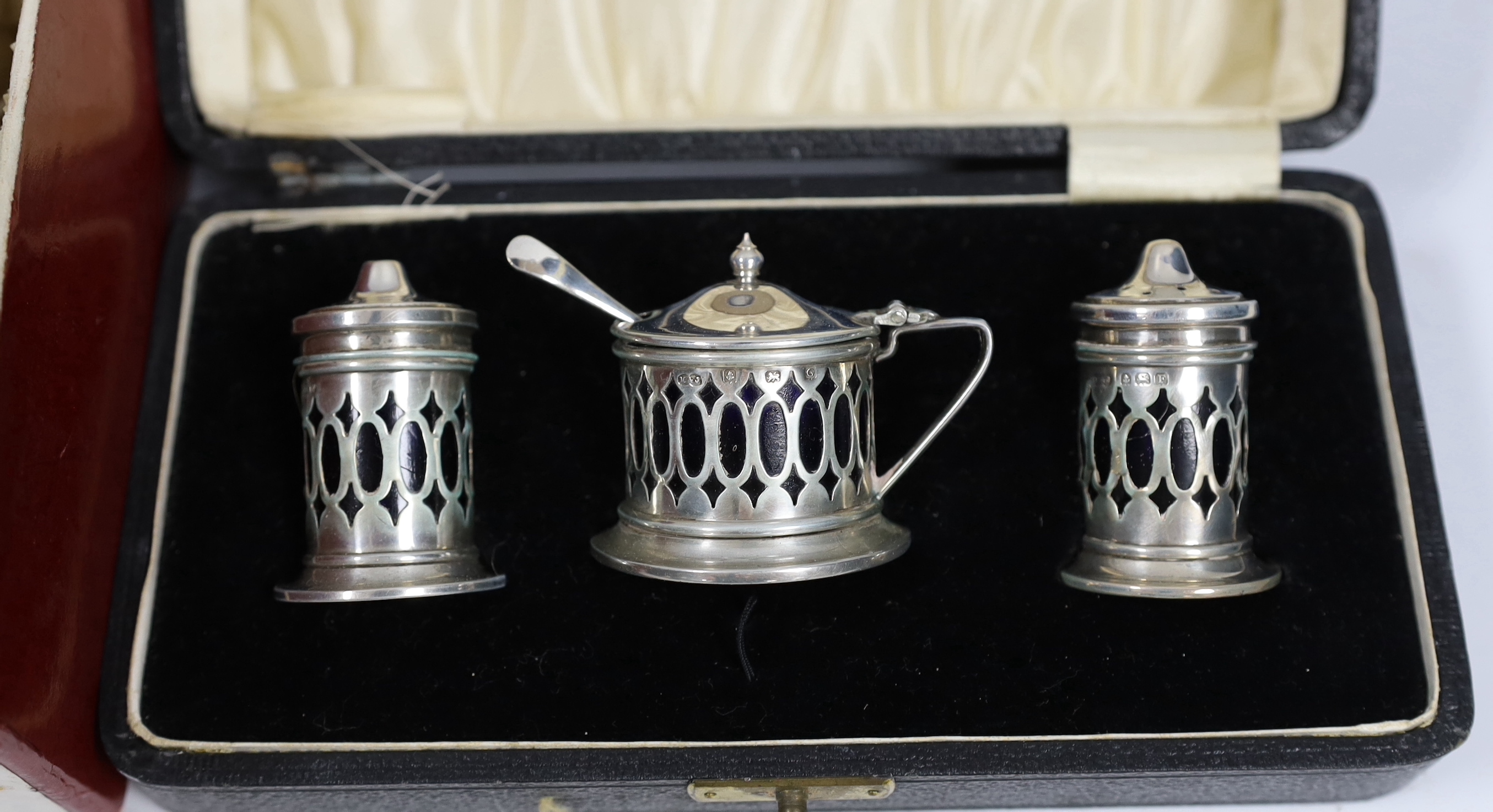 A George V silver nine piece condiment set, by Harrod's Ltd, Birmingham, 1933, a cased three piece silver condiment set and six other items including condiments and a table perpetual lighter.